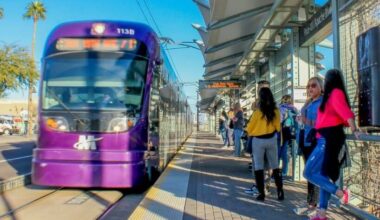 Riders wait for a Valley Metro light rail train.
