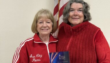 Poms president Sherry Cantrell and marching director Kathy Villa holds the trophy they were awarded.