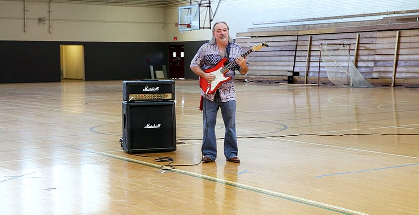 Rob Spindler, archivist with the ASU library, in a screenshot from a 2018 video produced by Ken Fagan of ASU Now, stands inside the gym on the Tempe campus where The Jimi Hendrix Experience performed on Feb. 5, 1968. Hendrix and the band warmed up for the show in the men’s locker room, the entrance to which can be seen in the background.