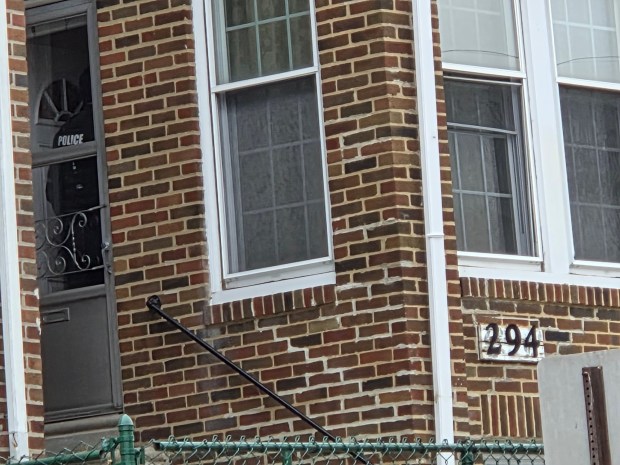 Police inside a house near the crime scene. (ALEX ROSE - DAILY TIMES)