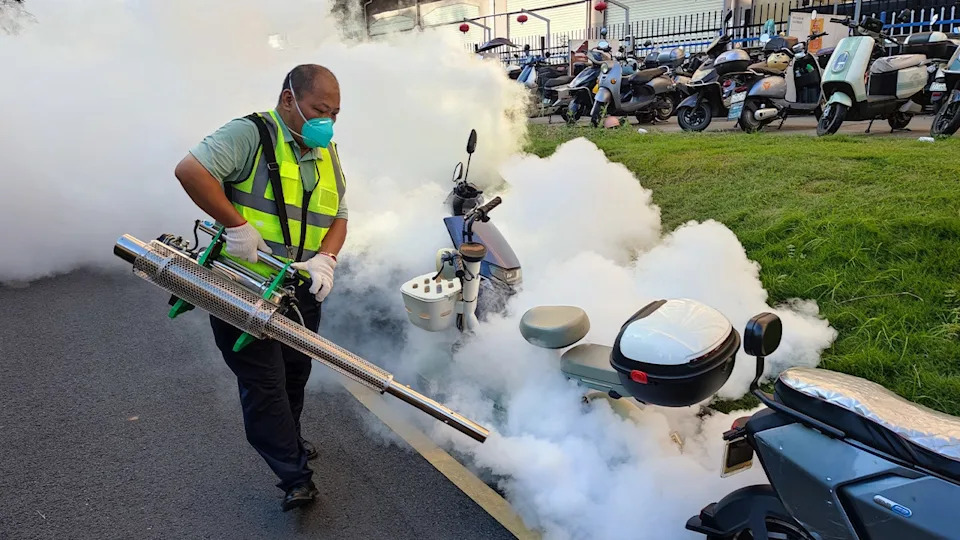 city worker sprays public areas