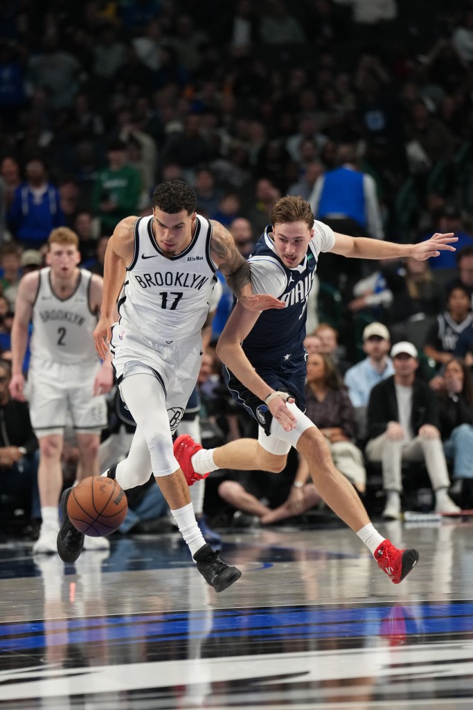 Michael Porter Jr. #17 of the Brooklyn Nets and Cooper Flagg #32 of the Dallas Mavericks battles for the ball during the game on December 12, 2025 at American Airlines Center in Dallas, Texas. 