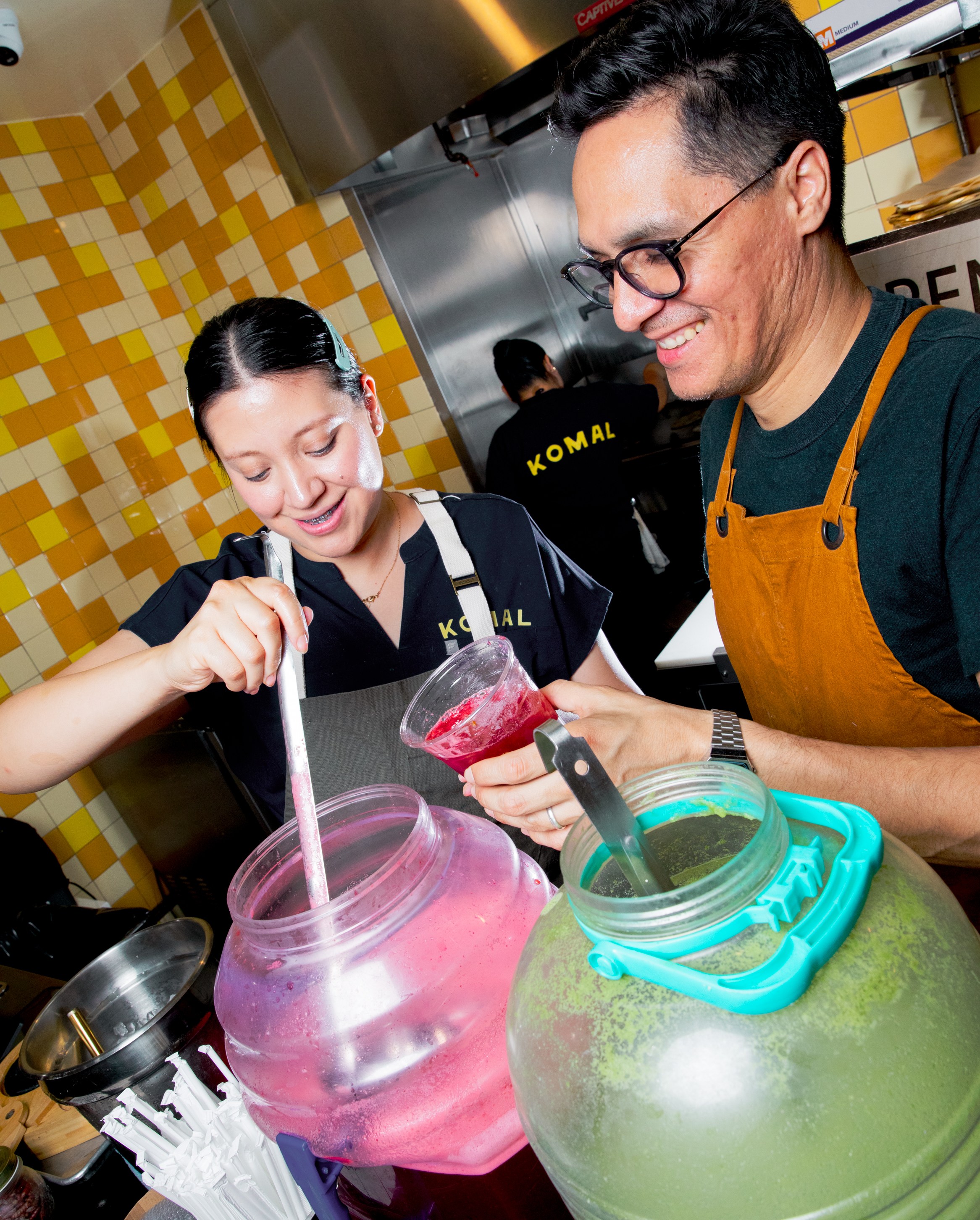 Chef Fátima Juárez and Conrado Rivera in front of the aguas frescas at Komal.