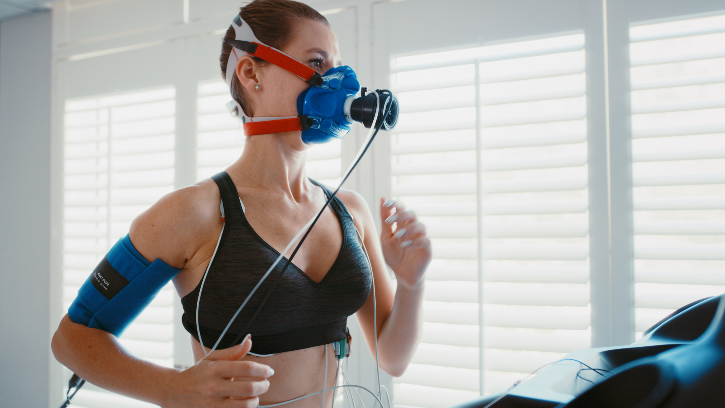Vo2 Max testing. A woman runs on a treadmill with a big facemask on