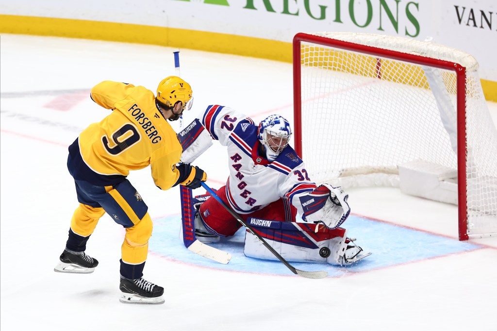 Jonathan Quick #32 of the New York Rangers makes the save of a shot from Filip Forsberg #9 of the Nashville Predators in the third period at Bridgestone Arena on December 21, 2025 in Nashville, Tennessee. 