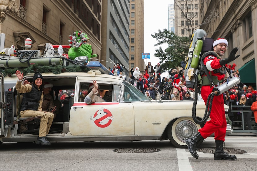 Ghostbusters wave at attendees during the Dallas Holiday Parade on Friday, Dec. 5, 2025, in...