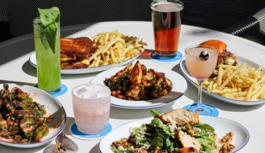 array of food and drinks on a white table