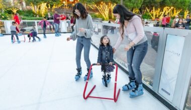 two women and a girl on an ice skating rink