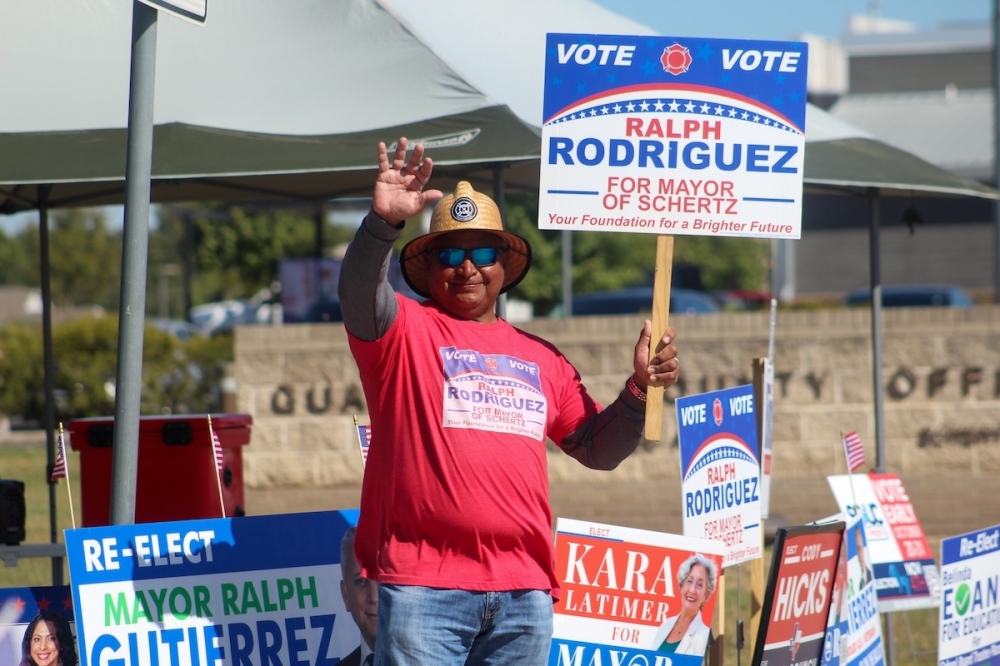 A hispanic man is seen campaigning for mayor of Schertz, Texas on a sunny afternoon.