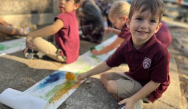 kids color on a sidewalk