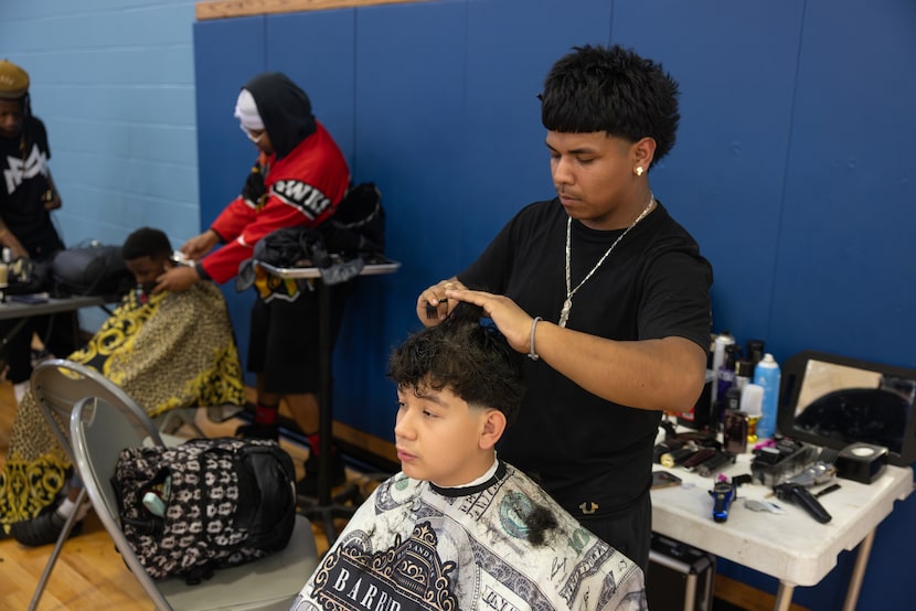 Kevin Sagrero gets his hair cut during a holiday drive organized by 'New Dallas' collective...