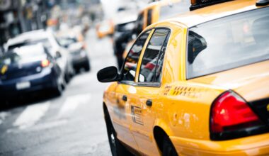 Yellow taxi driving along a street