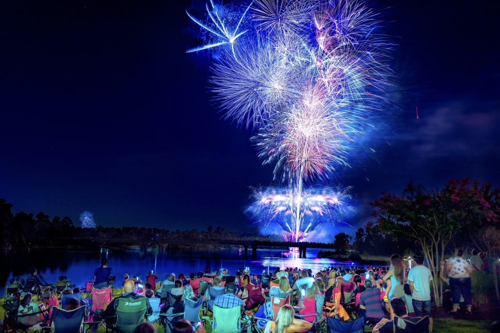 A photo of people gathering for fireworks outside.