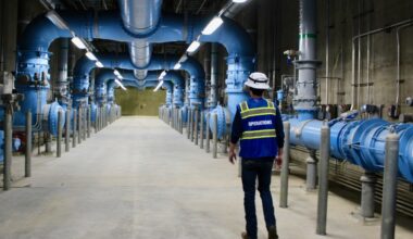 Masson Henderson, a water plant operator for the North Texas Municipal Water District, passes by filtration equipment at the Wylie Water Treatment Plant. Purified water flows through the equipment before being distributed to the select North Texas cities, including McKinney. (Shelbie Hamilton/Community Impact)