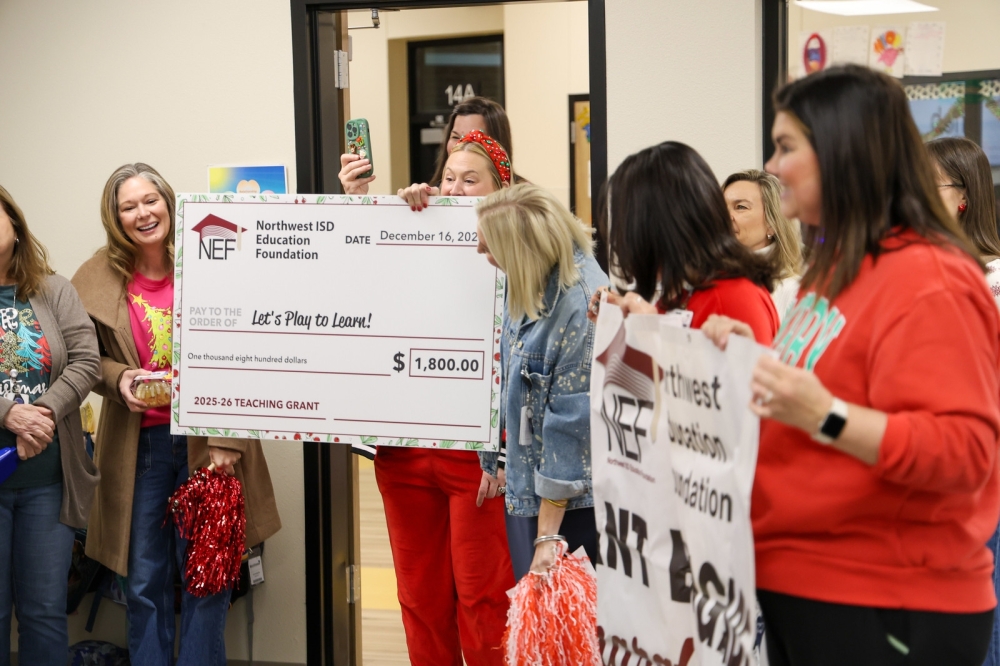 Teachers receiving an oversized grant check
