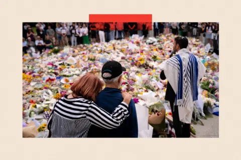 Getty Images People visit a memorial at Bondi Pavilion before a candlelight vigil at Bondi Beach