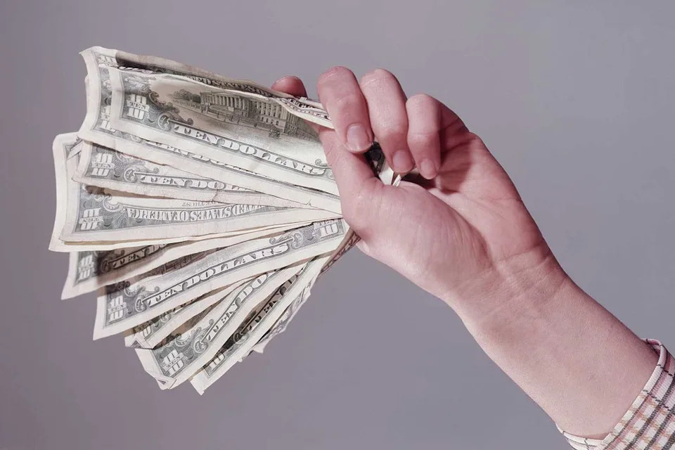 Getty Stock Images Hand holding cash (stock image)