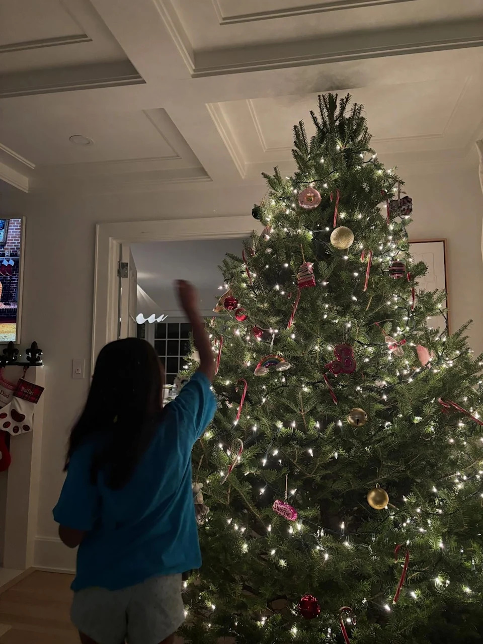In another image, Kotb carried her daughter on her shoulders as she placed the star at the top of the tree. <span class="image-credit">(Instagram)</span>