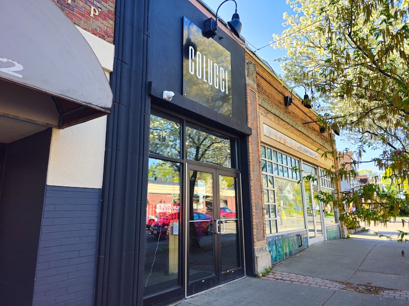 Exterior photo of Colucci restaurant, with a black facade and sign that reads "Colucci"