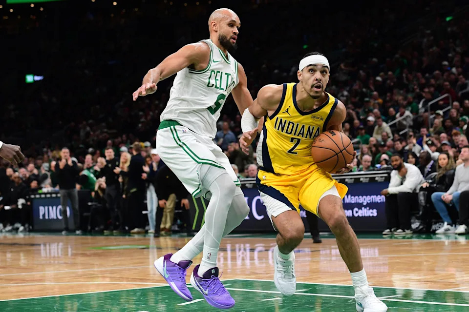 Dec 22, 2025; Boston, Massachusetts, USA; Indiana Pacers guard Andrew Nembhard (2) drives to the basket past Boston Celtics guard Derrick White (9) during the second half at TD Garden. Mandatory Credit: Bob DeChiara-Imagn Images