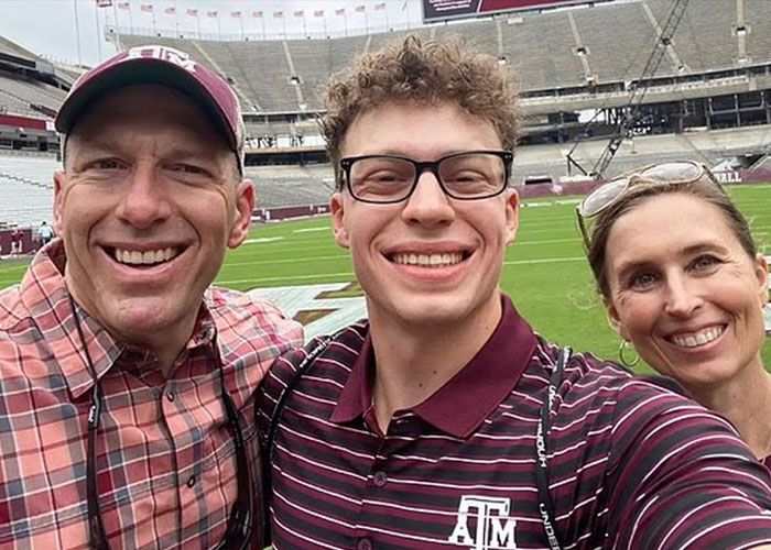 Three people smiling for a selfie in a stadium, conveying emotions related to ChatGPT faces the wrath of experts after teenager incident.