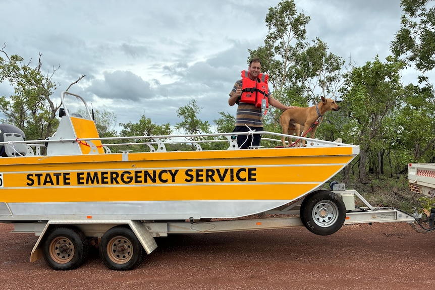 ses flood boat with man and dog on it.