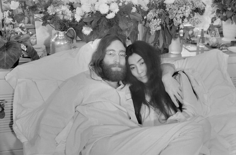 (Original Caption) Yoko and John...Beatle John Lennon and Yoko Ono, his bride of three months at the time this photo was made in Montreal in June 1969, pose in bed. His first solo album at the time featured songs telling of his love for Yoko. They held, in bed, press conferences in several cities with the theme, "make love, not war." Lennon was shot to death December 8, 1980. In a statement December 9th, Miss Ono said, "There is no funeral for John. Later in the week we will set the time for silent vigil to pray for his soul. We invite you to participate from wherever you are at the time."