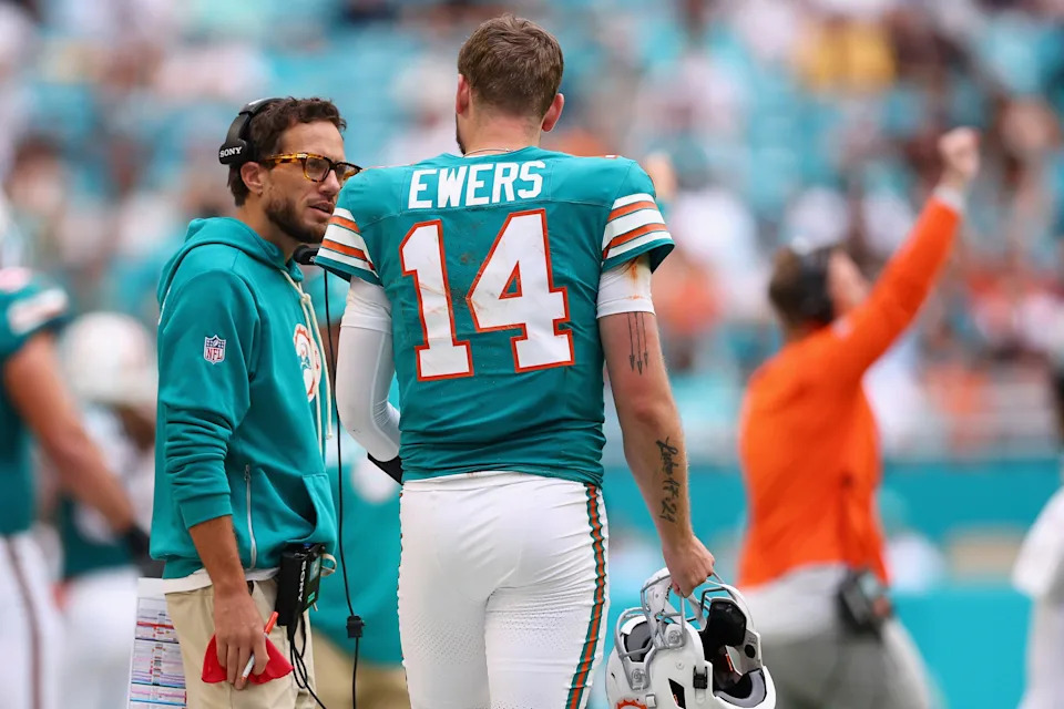 MIAMI GARDENS, FLORIDA - DECEMBER 21: Head coach Mike McDaniel and Quinn Ewers #14 of the Miami Dolphins talk after Ewers' interception against the Cincinnati Bengals in the third quarter of a game at Hard Rock Stadium on December 21, 2025 in Miami Gardens, Florida. (Photo by Megan Briggs/Getty Images)
