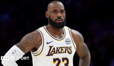 LeBron James stands on the court with his hands on his hips