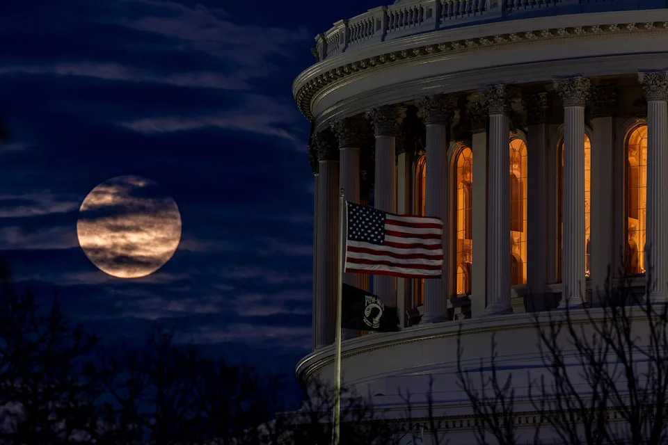 The cold supermoon rises behind the U.S. Capitol in Washington, D.C.