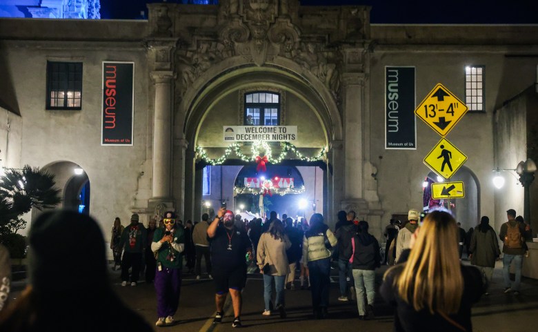 The facade of the Museum of Man at Balboa Park, with a crowd lingering outside.