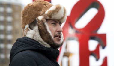 Nassim Hassanzada keeps his head warm against the cold wind at LOVE Park in Philadelphia on Monday. After what will be a very brief warmup, temperatures will crash Friday with wind gusts to 50 mph.