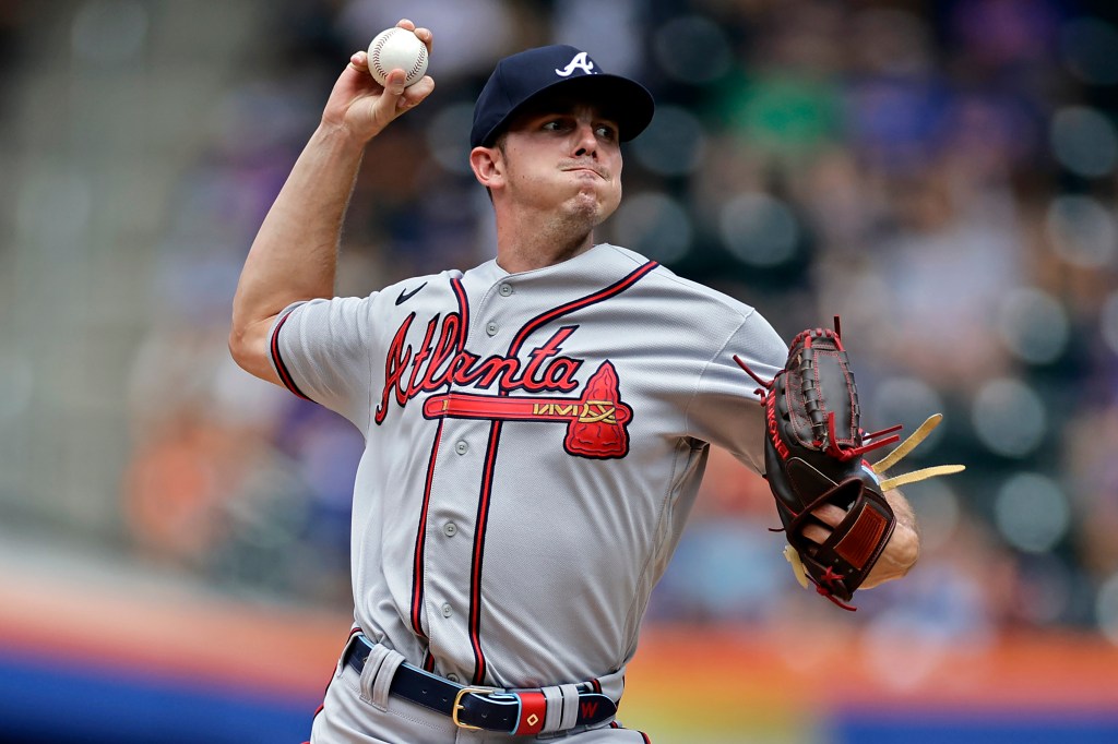 A baseball player for the Atlanta Braves pitching.