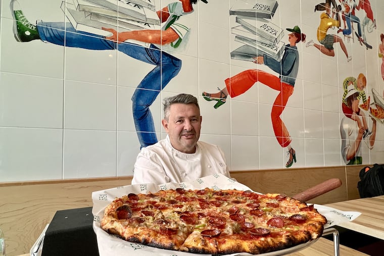 Chef Laurent Tourondel with a pepperoni and sausage pizza at Scusi Pizza, 1099 Germantown Ave.