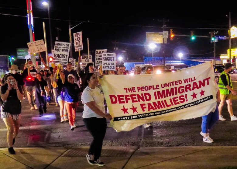Protesters carry a banner during a demonstration last month against the recent multi-agency raid.
