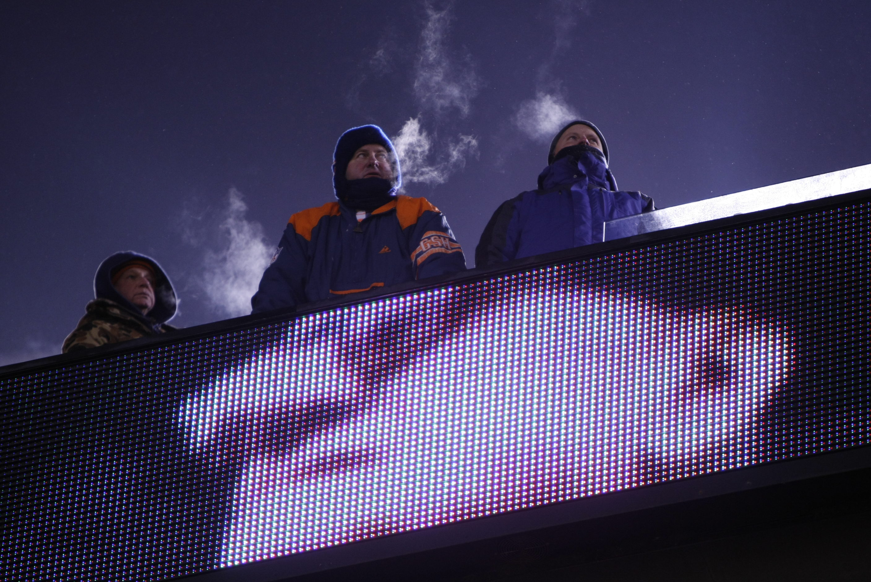 Bears Fans watch the action as an image of George...