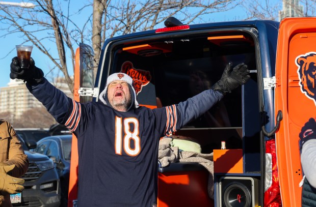 Troy Perrin of Palatine sings along to AC/DC while tailgating before a Bears-Browns game Sunday, Dec. 14, 2025, at Soldier Field. (Dominic Di Palermo/Chicago Tribune)