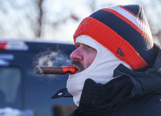 Aaron Cooper of Benld smokes a cigar while tailgatingbefore a Bears-Browns game Sunday, Dec. 14, 2025, at Soldier Field. (Dominic Di Palermo/Chicago Tribune)