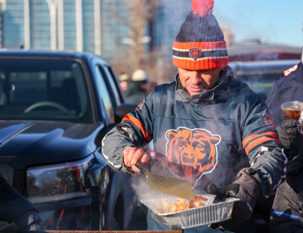 Alex Idriz cooks shrimp while tailgating before a Bears-Browns game Sunday, Dec. 14, 2025, at Soldier Field. (Dominic Di Palermo/Chicago Tribune)