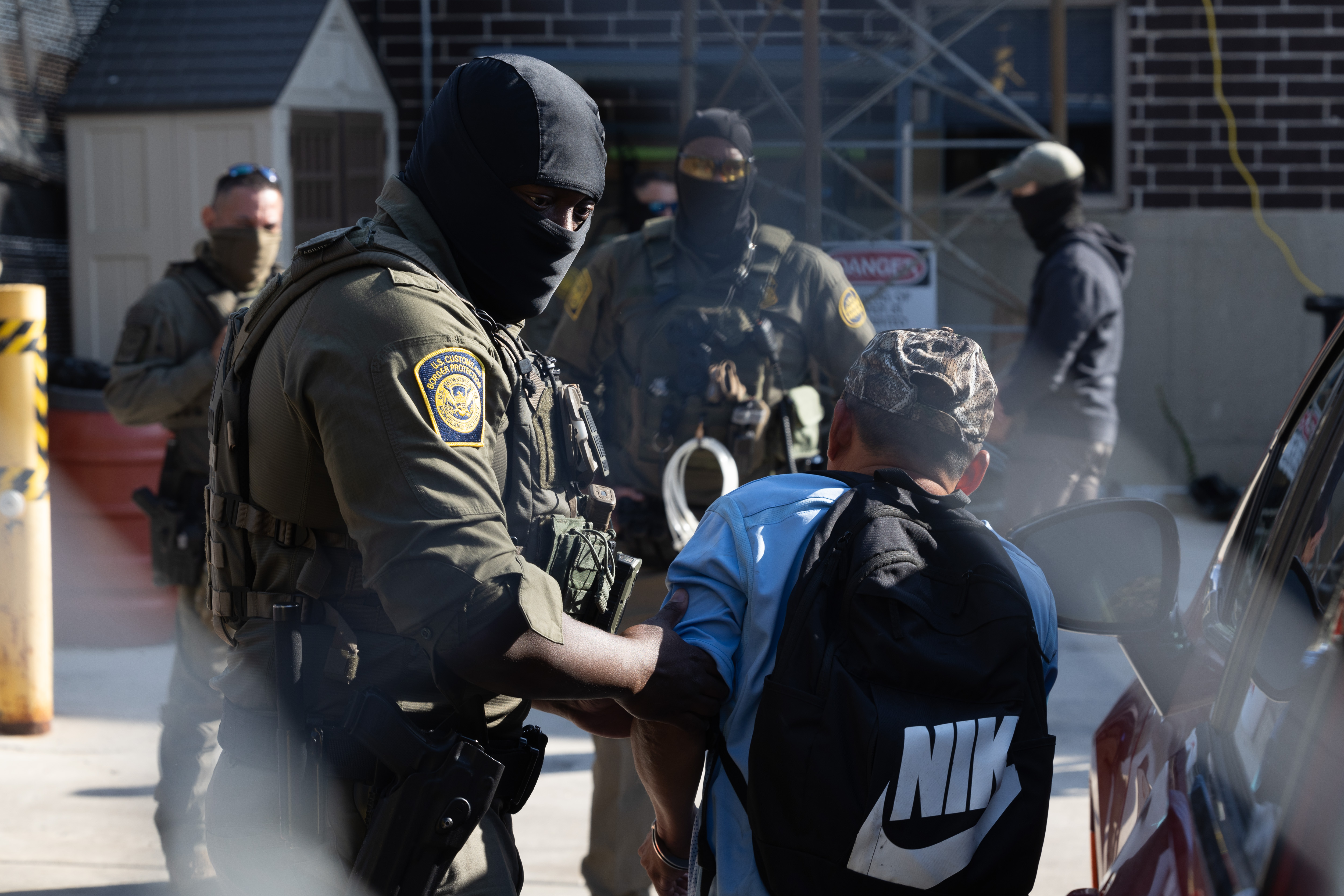A detainee is unloaded from a vehicle before being brought...
