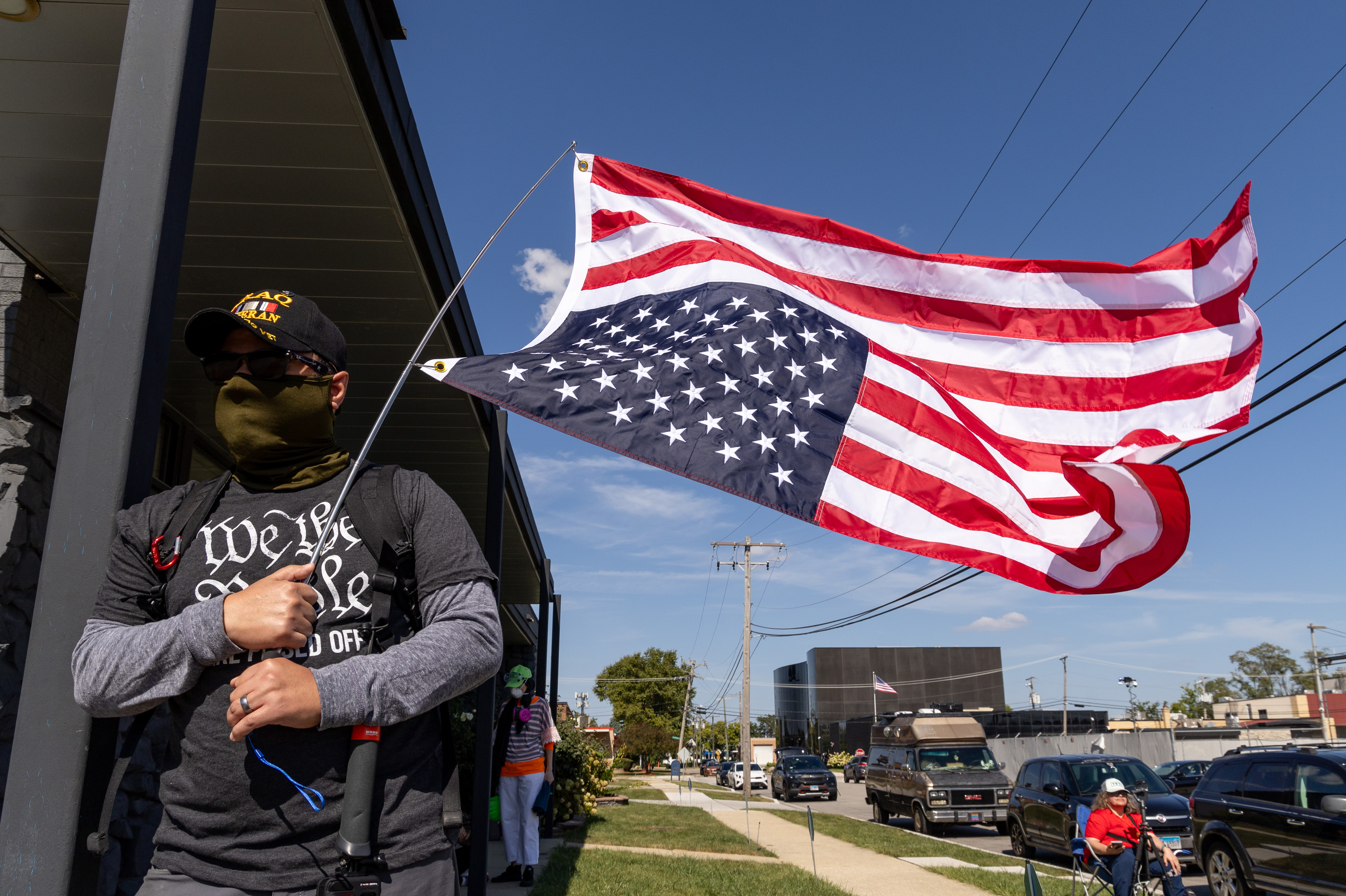 A protester and veteran who served in Iraq flies the...