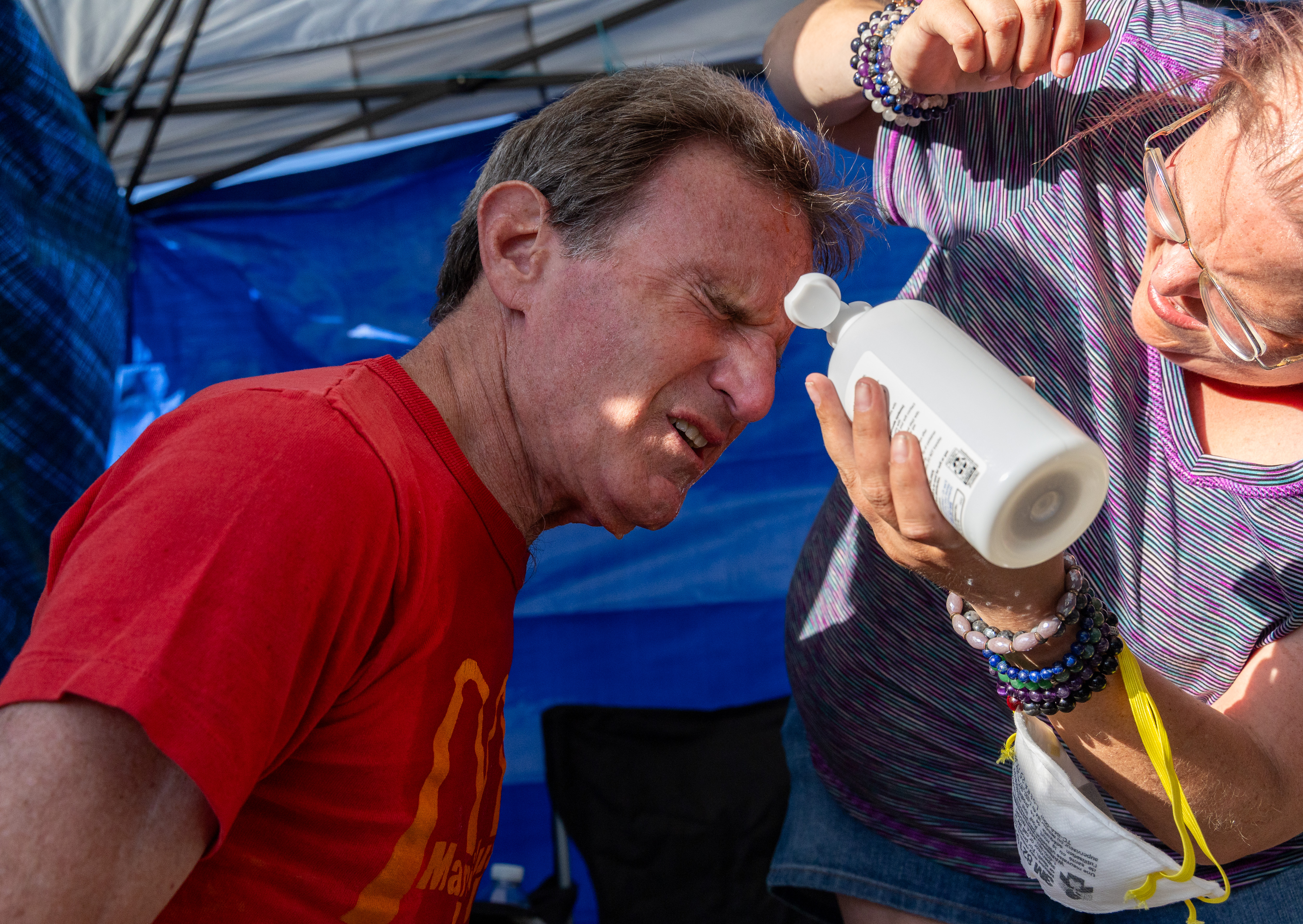 A protester gets treated after being sprayed by a federal...