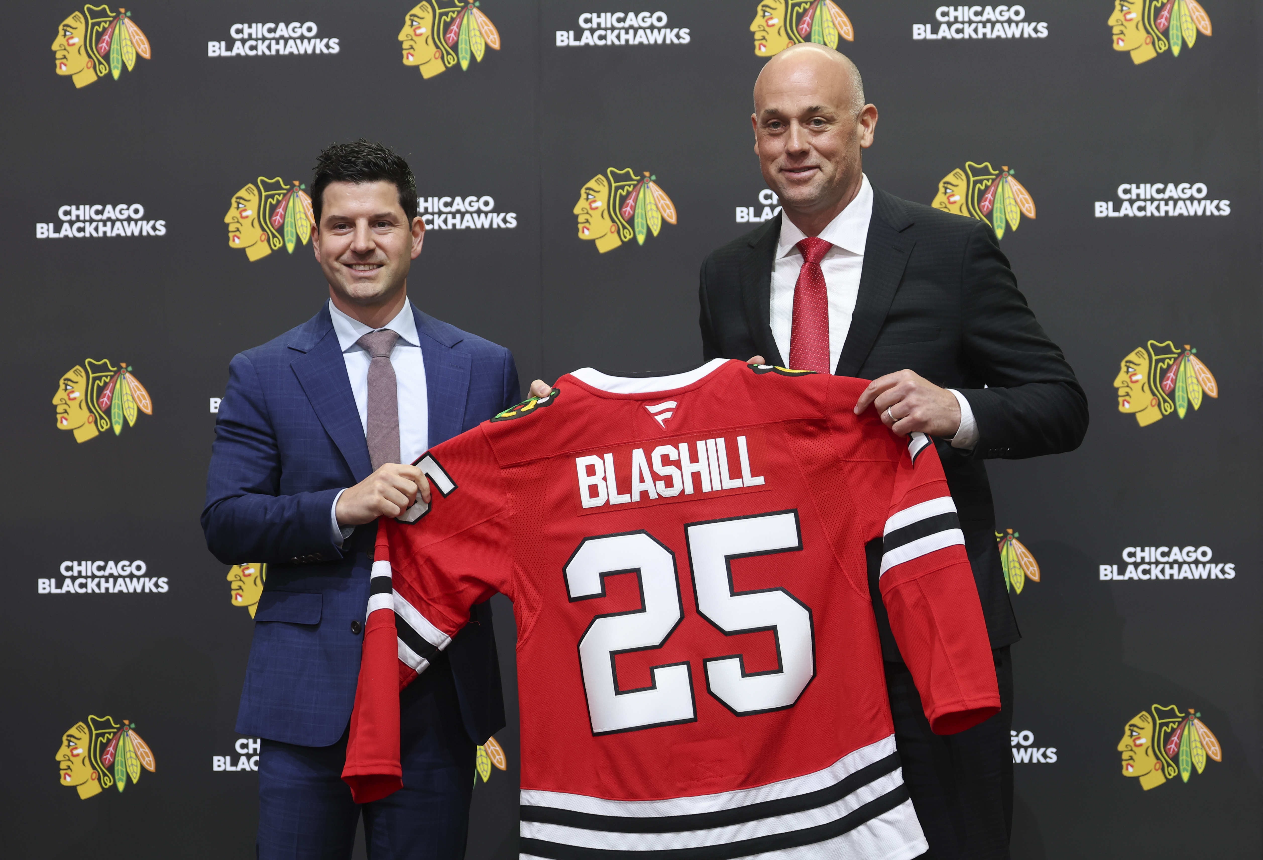 Chicago Blackhawks General Manager Kyle Davidson, left, poses with new...