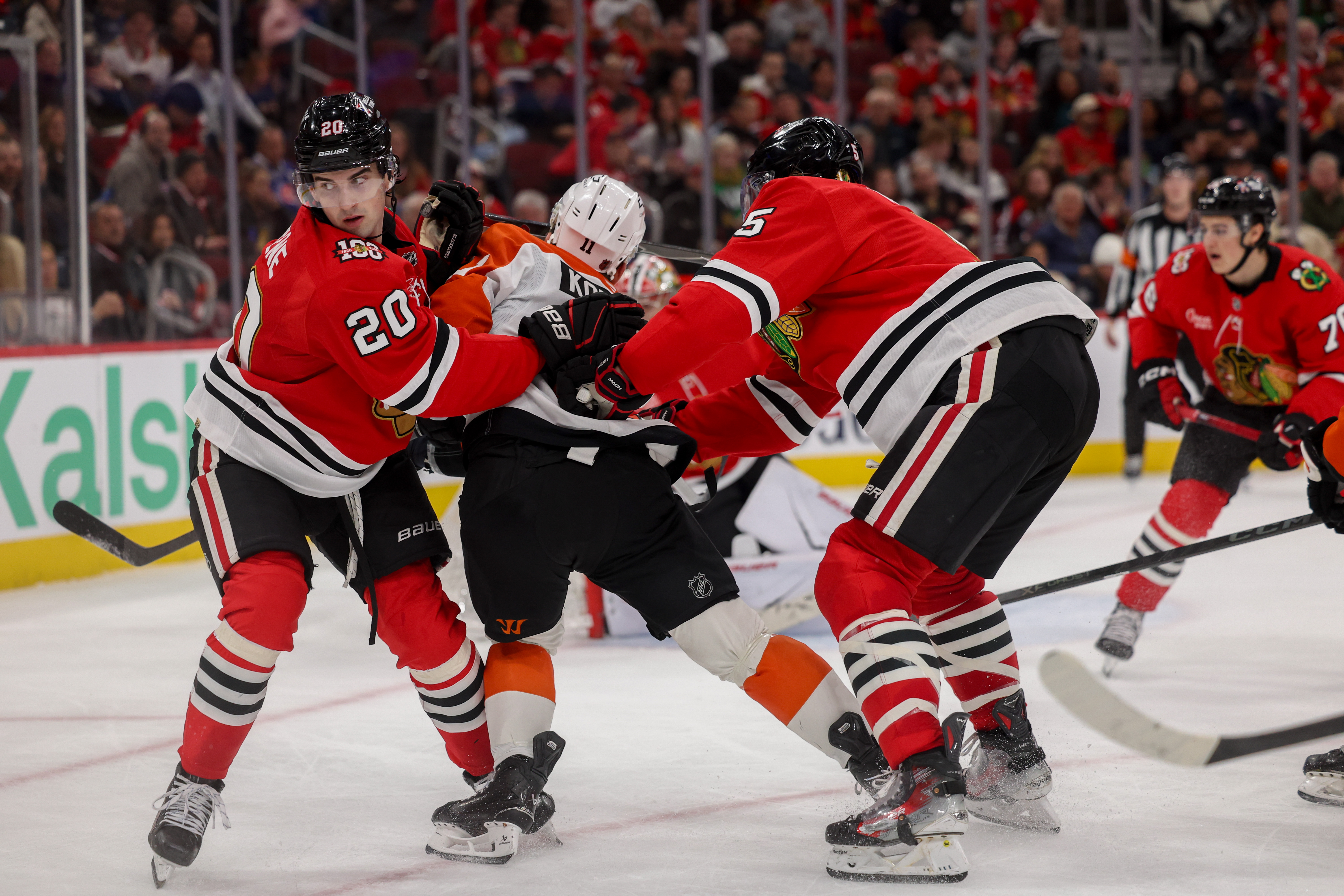 Chicago Blackhawks defenseman Connor Murphy (5) and Chicago Blackhawks center Ryan Greene (20) push Philadelphia Flyers right wing Travis Konecny (11) during the second period at the United Center Tuesday Dec. 23, 2025 in Chicago. (Armando L. Sanchez/Chicago Tribune)