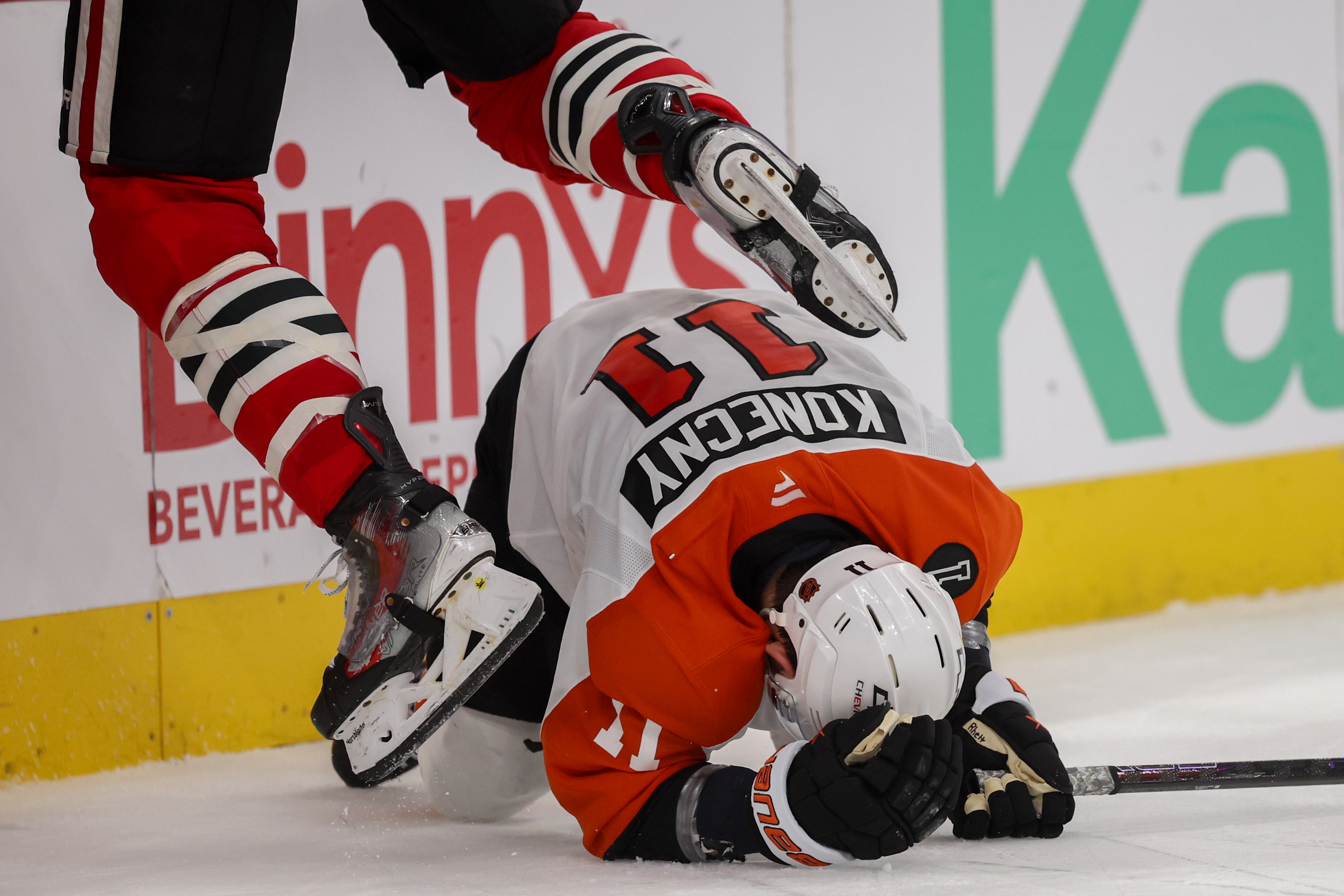 Chicago Blackhawks defenseman Connor Murphy (5) jumps over Philadelphia Flyers right wing Travis Konecny (11) during the second period at the United Center Tuesday Dec. 23, 2025 in Chicago. (Armando L. Sanchez/Chicago Tribune)