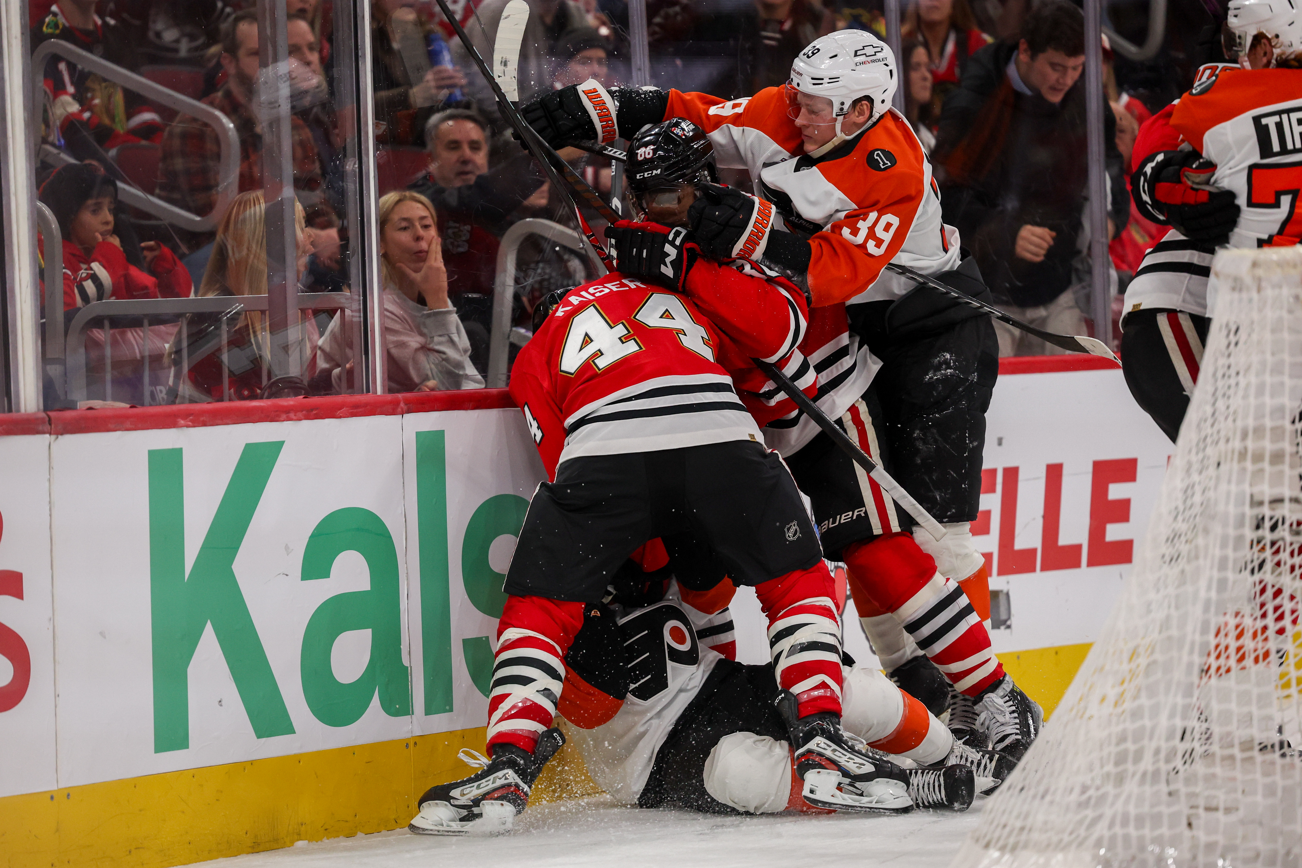 Philadelphia Flyers right wing Matvei Michkov (39) pushes on Chicago Blackhawks center Teuvo Teravainen (86) while Chicago Blackhawks defenseman Wyatt Kaiser (44) stands over Philadelphia Flyers center Denver Barkey (52) during the second period at the United Center Tuesday Dec. 23, 2025 in Chicago. (Armando L. Sanchez/Chicago Tribune)