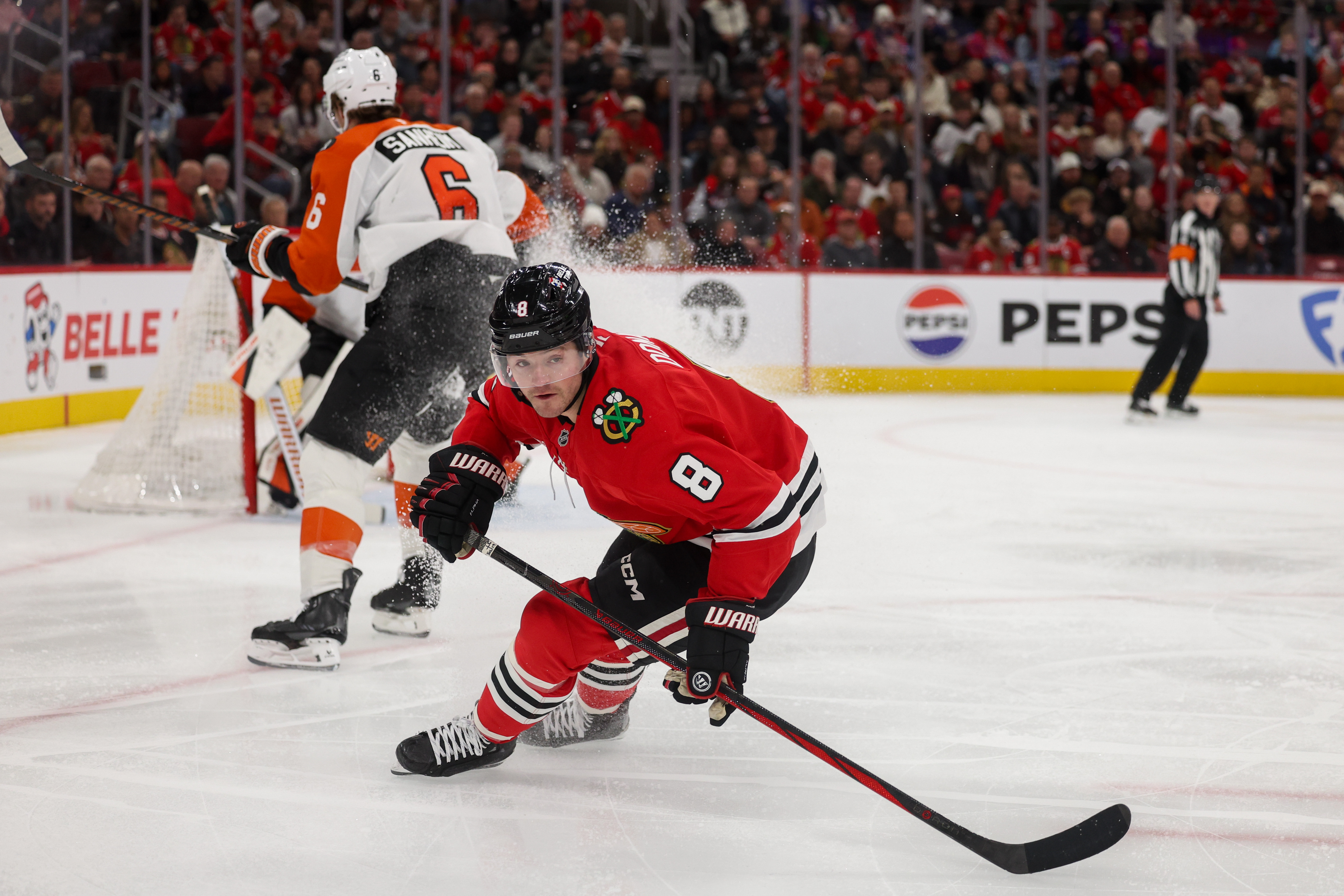 Chicago Blackhawks center Ryan Donato (8) chases after the puck during the first period against the Philadelphia Flyers at the United Center Tuesday Dec. 23, 2025 in Chicago. (Armando L. Sanchez/Chicago Tribune)