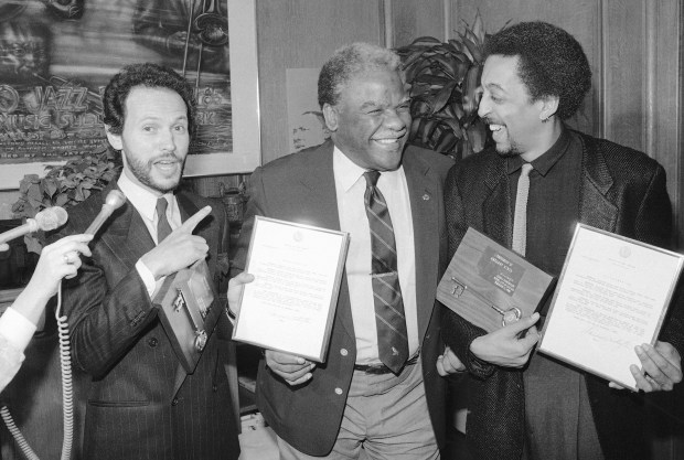 Chicago Mayor Harold Washington, center, gives keys to the city to Billy Crystal, left, and Gregory Hines in his office after proclaiming it "You look Marvelous Day" on Dec. 13, 1985, in Chicago. Hines and Crystal are in Chicago to film the movie "Running Scared." The two were given the awards for their work on behalf of the Chicago Neighborhood Festival Program. (Charlie Bennett/AP)