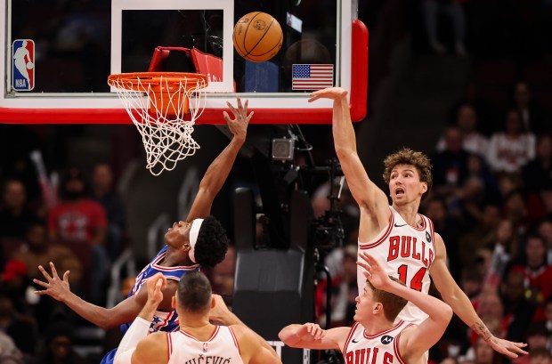 Chicago Bulls forward Matas Buzelis (14) blocks Philadelphia 76ers guard Vj Edgecombe's (77) layup in the second quarter, Sunday, Dec. 26, 2025, at the United Center in Chicago. (Dominic Di Palermo/Chicago Tribune)