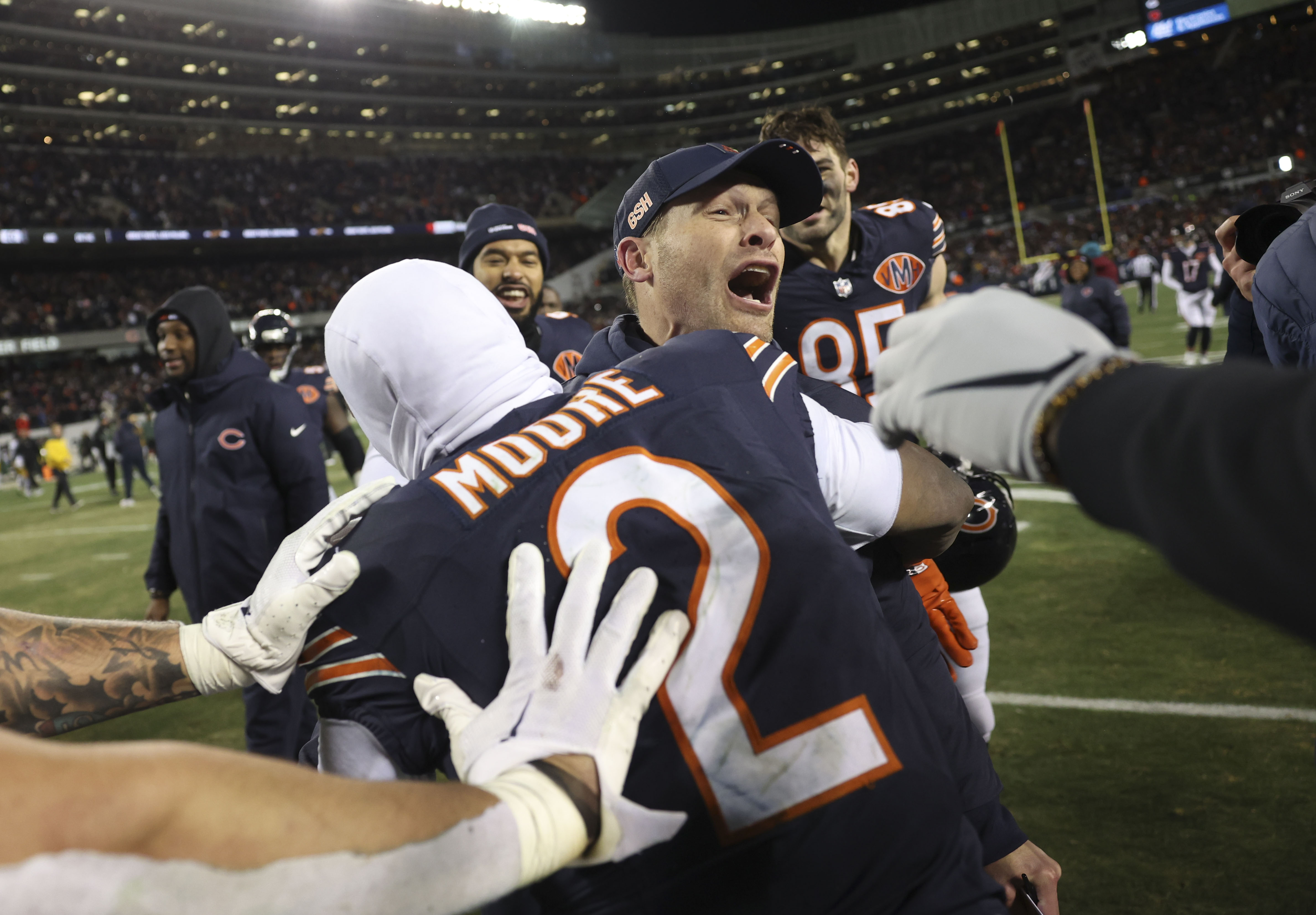 Chicago Bears head coach Ben Johnson celebrates the win with...